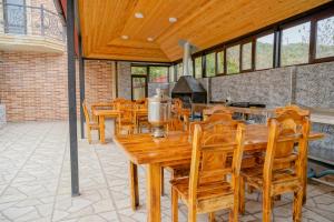 a dining room with wooden tables and chairs at Qusar Boutique in Qusar