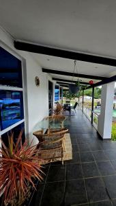 a patio with a glass table and some plants at Tranquil stay and venue in the heart of Ixopo in Ixopo