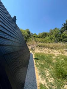 a roof of a building next to a field at A frame Miška in Nána +7 photos
