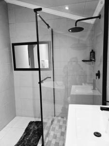 a bathroom with a shower and a sink and a tub at Tranquil stay and venue in the heart of Ixopo in Ixopo
