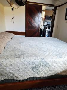 a bedroom with a large bed with a wooden door at Varandas de Pirangi in Parnamirim +32 photos