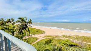a balcony view of a beach with palm trees and the ocean at Setai Aquamaris by Setai Apartaments in João Pessoa