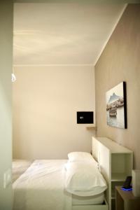 a bedroom with a bed and a tv on the wall at Parthenope Luxury Apartment in Naples +52 photos