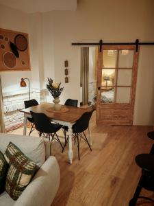 a living room with a table and chairs and a door at Apartment Relić in Sombor
