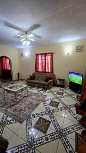 een woonkamer met een bank en een tv bij NR Investments in Kingstown