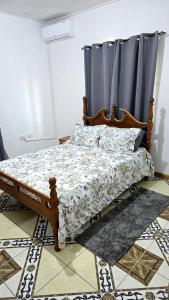 een slaapkamer met een bed met een gordijn bij NR Investments in Kingstown