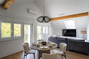 a living room with a table and a couch at Villa Peregrine Plitvice Lakes 