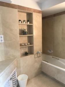 a bathroom with a tub and a toilet and a sink at La Manga Club, Las Palmeras 12 in Cartagena +11 photos