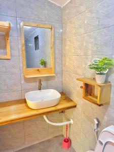 a bathroom with a sink and a mirror at J&T Homestay in Karatu