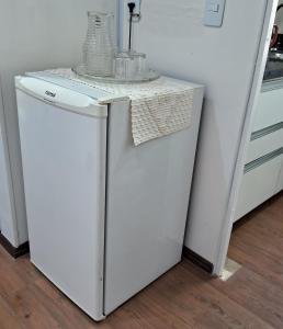 a white refrigerator with a counter top on top of it at Apartamento aconchegante na Asa Norte in Brasilia