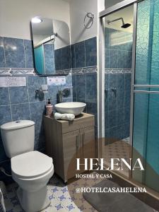 a bathroom with a toilet and a sink and a shower at HC Helena in Filandia +19 photos