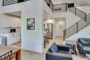 a kitchen and living room with a staircase and a table at Luxe, New-Build Sturgis Retreat with Mountain Views in Crook City