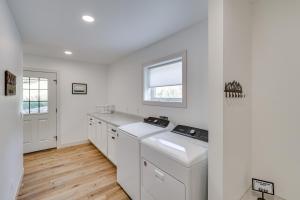 a kitchen with white cabinets and a window at Luxe, New-Build Sturgis Retreat with Mountain Views in Crook City +30 photos