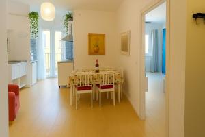 a kitchen and dining room with a table and chairs at Domus Appio Latino - Parco Appia Antica in Rome
