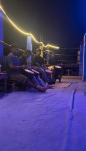 a group of people sitting in a boxing ring at The Last Stop Backpackers Hostel in Auroville