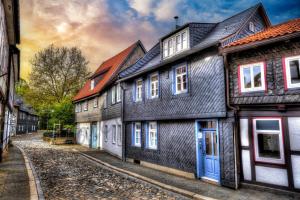 a row of houses on a cobblestone street at Lillis Cottage in Goslar