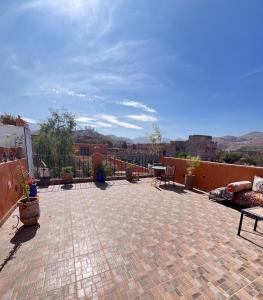 a patio with a table and chairs on a roof at Dar Ben Idar Atlas Mountains in Tahannout