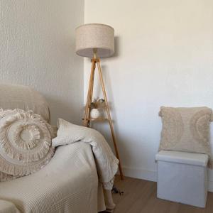 a lamp sitting next to a bed with a chair at Piso en el corazon de Las Torres de Cotillas in Las Torres de Cotillas