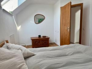 Un dormitorio con una cama y un espejo en la pared. en Kleine Oase im Grünen!, en Heiligenhaus