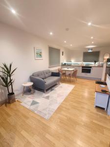 a living room with a couch and a table at Hillside Park Studio in Easter Quarff