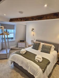a bedroom with a large bed with towels on it at The Loft at 2 Bath Street in Bath