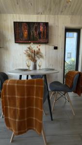 a table and chairs in a room with a wall at ForRest будинок з чаном in Moshchun