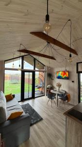 a living room with a couch and a table at ForRest будинок з чаном in Moshchun