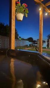 a potted plant hanging from a wooden pergola at ForRest будинок з чаном in Moshchun