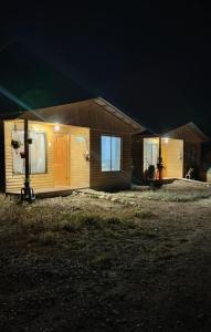 a small house at night with the lights on at cabaña elquimilen in Vicuña