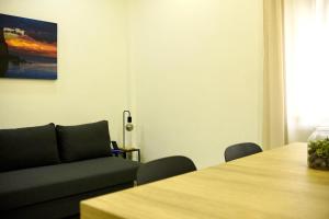 a living room with a couch and a table at Parthenope Luxury Apartment in Naples