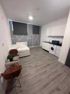 a large room with a bed and a kitchen at Lovely Studio Flat in Edgware HA8 in Edgware