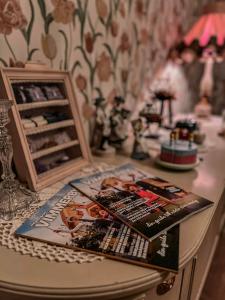 a table with a book and a picture on it at Daisy's Home Vimmerby in Vimmerby