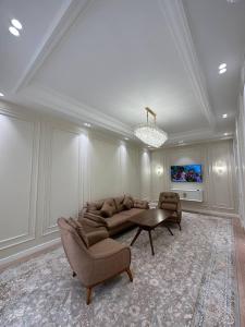 a living room with a couch and a table at BOULEVARD NEST RESlDENCE in Tashkent
