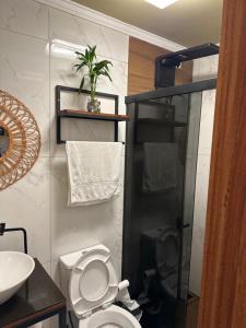 a bathroom with a toilet and a sink at Containersblack in Florianópolis