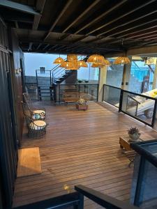 a deck with chairs and chandeliers on a building at Containersblack in Florianópolis