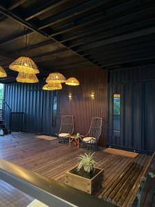 a room with two chairs and chandeliers at Containersblack in Florianópolis