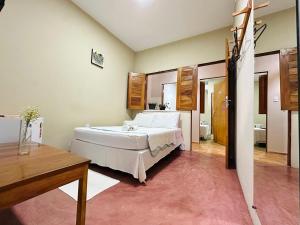 a bedroom with a large white bed in a room at Pousada Zoom Jericoacoara in Jericoacoara