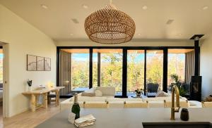 a living room with a couch and a table at Será at Sandy Ridge - Brand New Modern WV Retreat in Wardensville