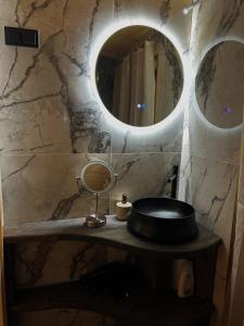a bathroom with a sink and a mirror at Northern lights Ivalo Stay in Ivalo +19 photos