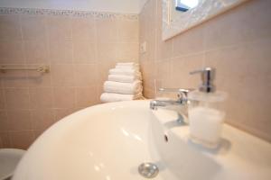 ein Bad mit einem Waschbecken, einem WC und Handtüchern in der Unterkunft Agriturismo Villa Caterina in Levanto + 46 Fotos