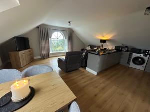 a living room with a table with a candle on it at Conors view in Annagry