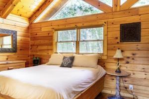 a bedroom with a bed in a log cabin at Sereni-Tree Cabin in the Smokey Mountains in Sevierville