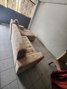 a couch sitting on the floor in a room at Departamento citrine in Cajamarca