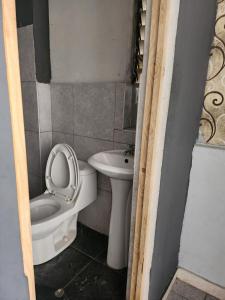 a small bathroom with a toilet and a sink at Departamento citrine in Cajamarca