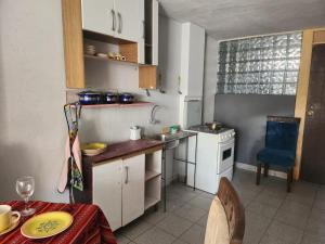 a kitchen with a sink and a table in it at Departamento citrine in Cajamarca
