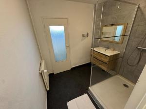 Un baño con ducha, lavabo y espejo. en Grand appartement lumineux, en Beauvais 14 fotos más