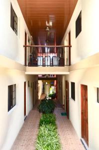 an empty hallway of a building with plants at Hotel San Jose Matagalpa in Matagalpa