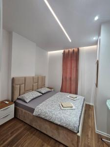 a bedroom with a bed in a room at Univers City Apartment in Tirana