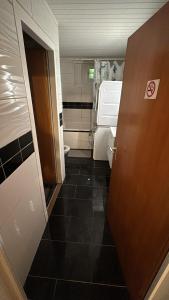 a small bathroom with a toilet and a door at Private room in the big house Bolligen in Bolligen