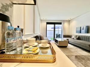 a living room with a gold tray with a bottle of water at Spacious, Quiet Apartment with Parking , Fiber in Casablanca